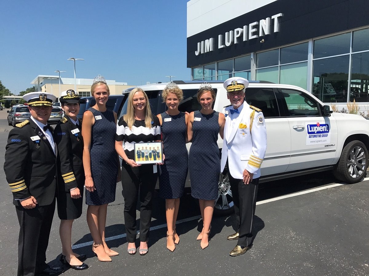Lupient Auto Group accepts their sponsorship plaque from the Aquatennial royalty team
